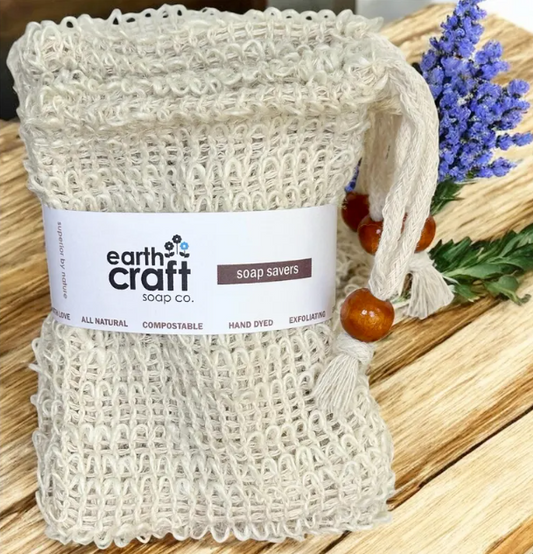 Earth Craft soap saver with a label on a wooden surface with lavender flowers.